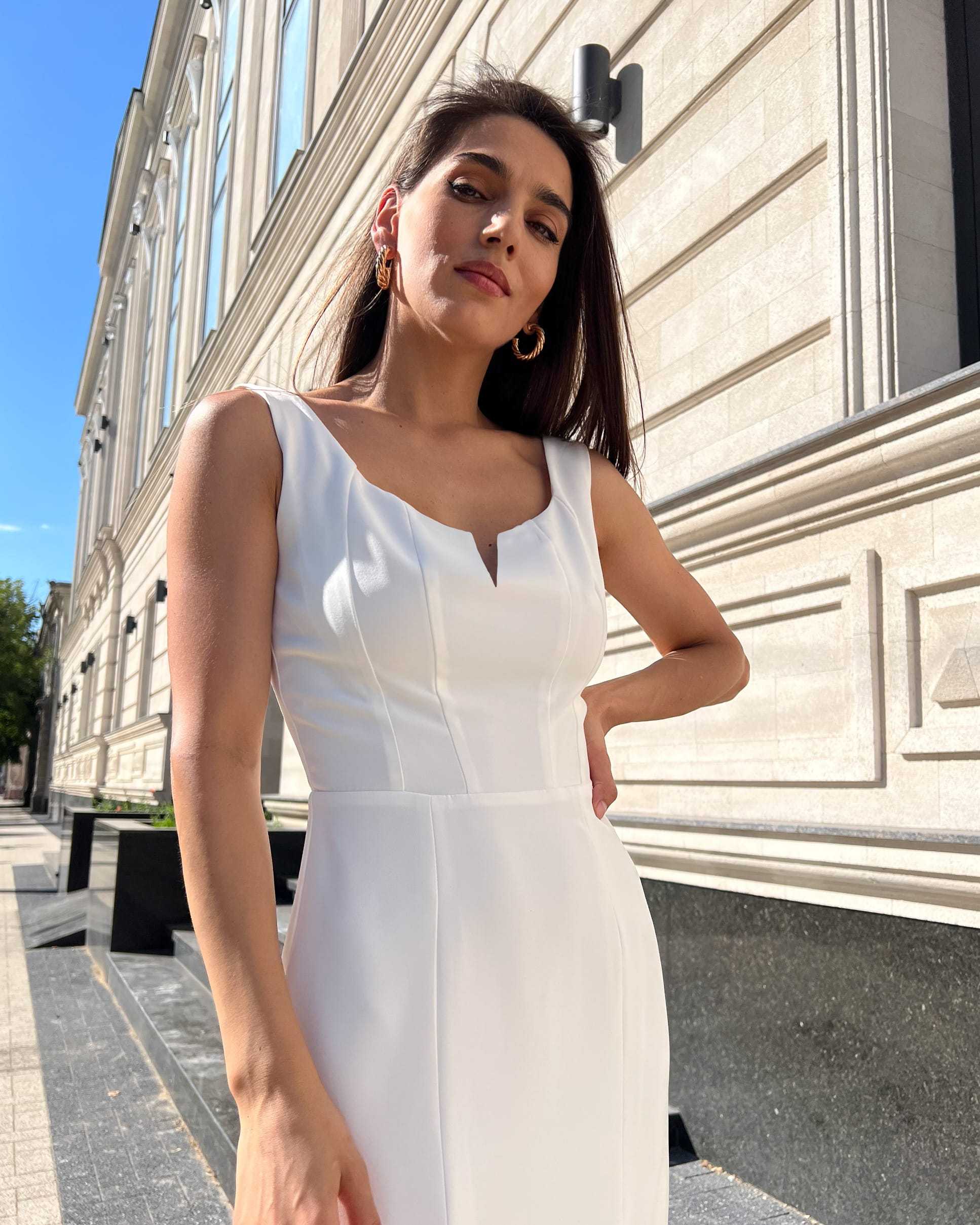 Rochie cocktail albă elegantă fără mâneci, material crep elastic, rafinată și ajustată, cu slit pe piciorul stâng.